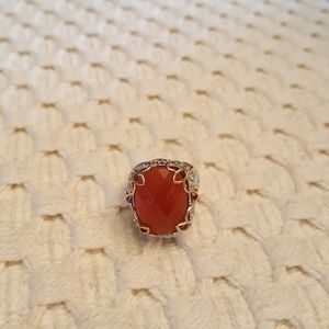 Carnelian ring with orange sapphire side stones.